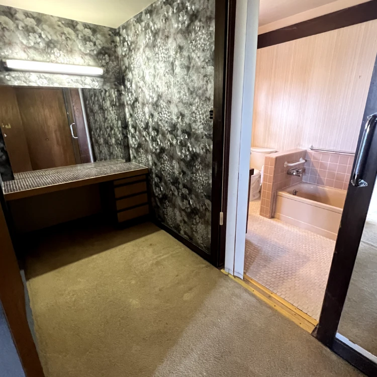 a bathroom with a mirror and a bathtub