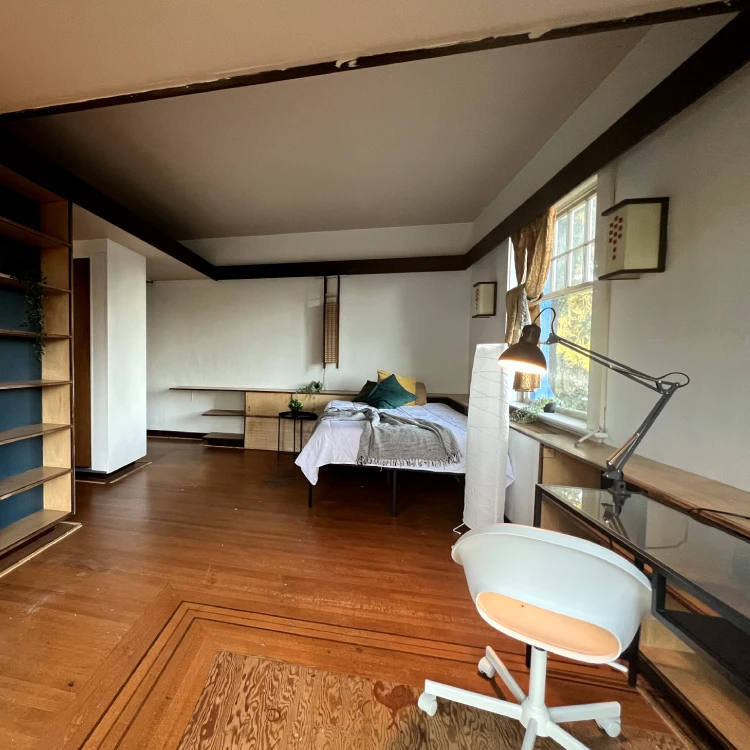 a room with a bed and a desk